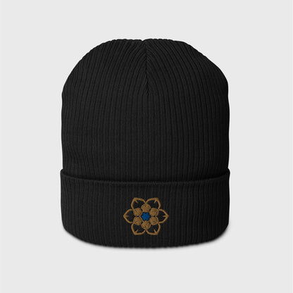 A black ribbed beanie featuring an embroidered logo in the shape of the Wanderer's hat, a gold 6 point hexagonal frame around a filled in black with another gold filled shaped inside and a blue figure in the centre.