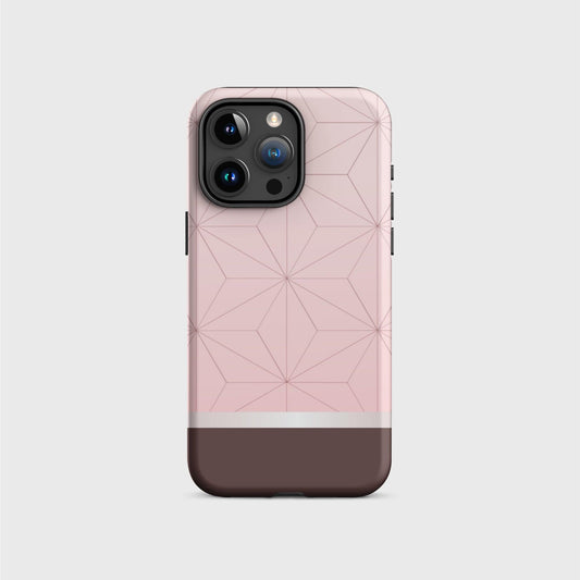 A tough iPhone case featuring Nezuko’s pink kimono pattern with geometrical pattern. A white division 3/4 vertically from the bottom separates the pattern from a brown base.