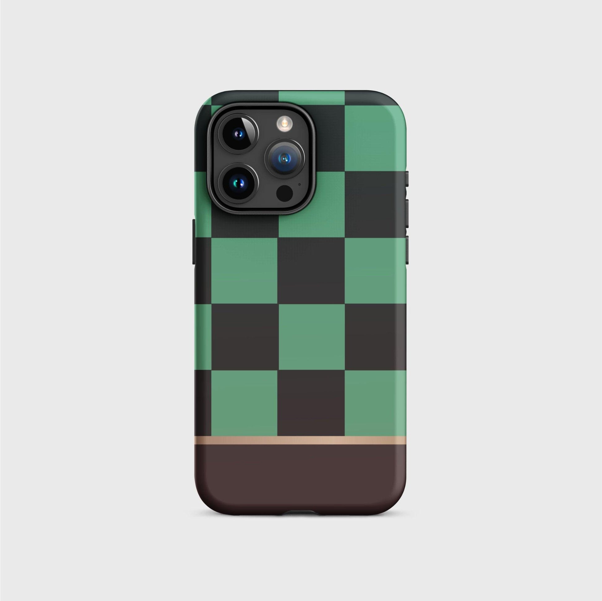 A tough iPhone case featuring Tanjiro’s black and green checkered kimono pattern. A gold division 3/4 vertically from the bottom separates the pattern from a brown base.