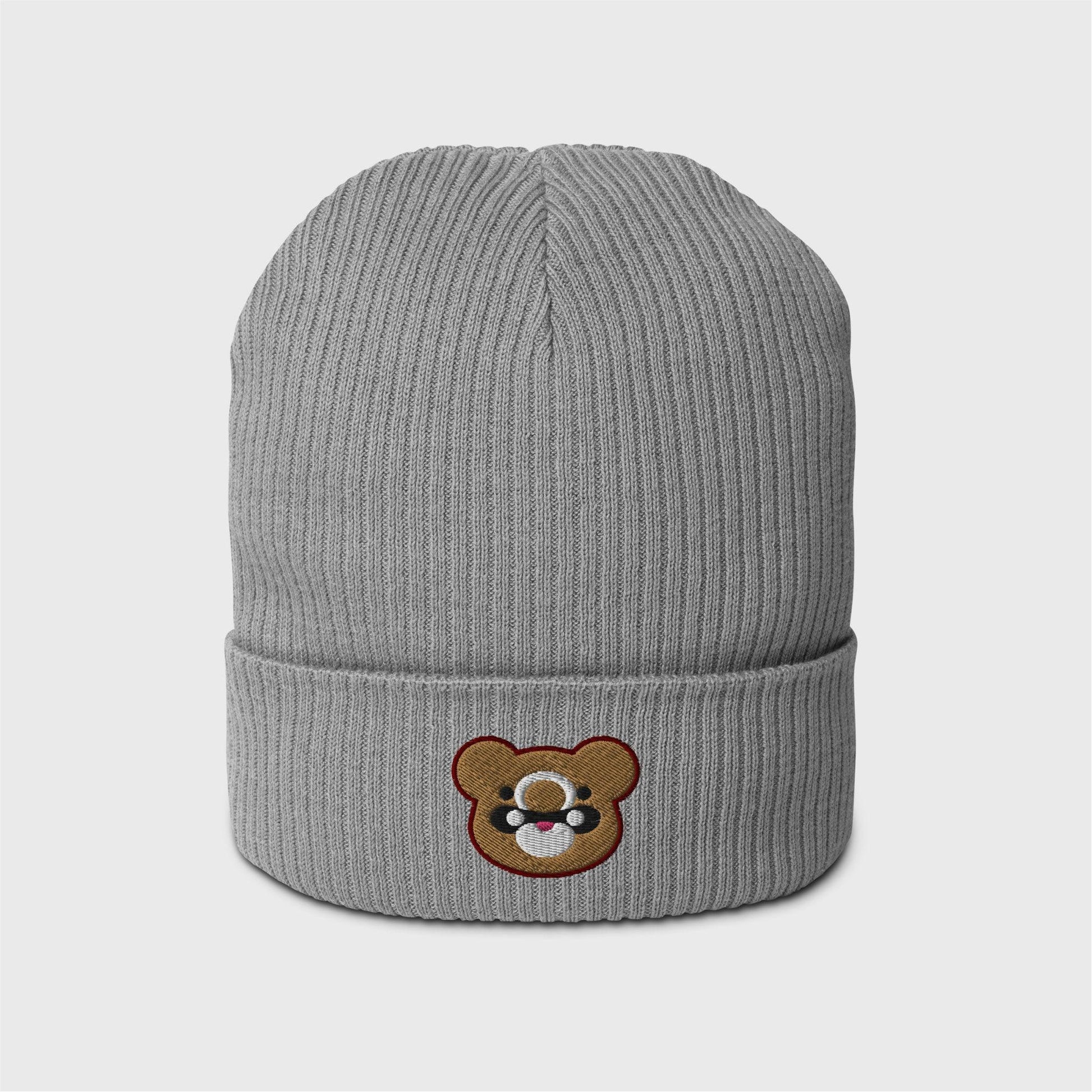 A light grey ribbed beanie featuring an embroidered bear head shape of Gouda in gold, with black and white marks and lined in dark red.