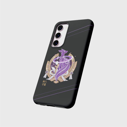 A samsung tough case with a soft black gradient going from darker on the top to brighter on the bottom, featuring a purple electro fox surrounded by a golden half moon element from Yae’s outfit. Behind the fox, sakura blossom petals fall on the background. Her name shows in gold Japanese characters at the bottom left of the design. Soft purple lines cross the top and bottom of the case diagonally.