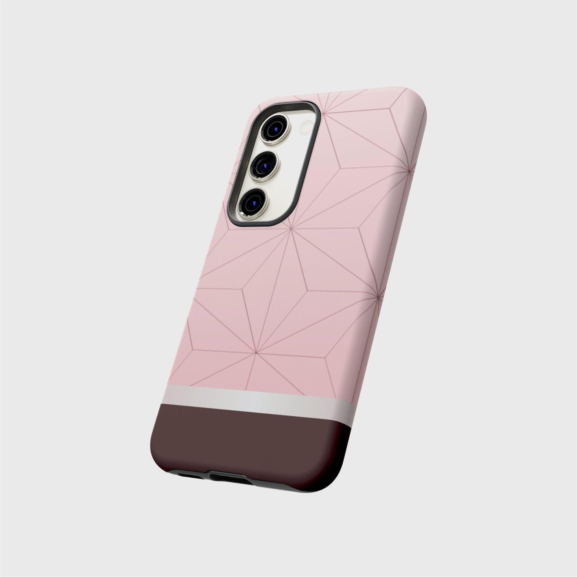 A tough Samsung case featuring Nezuko’s pink kimono pattern with geometrical pattern. A white division 3/4 vertically from the bottom separates the pattern from a brown base.