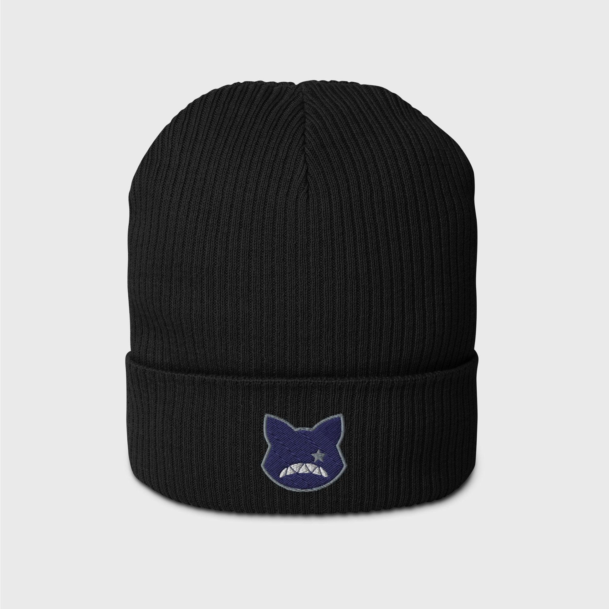 A black ribbed beanie featuring an embroidered navy logo shaped as a cat’s head, lined in grey, showing only a right grey eye the shape of a star and a upside down fanged white smile.